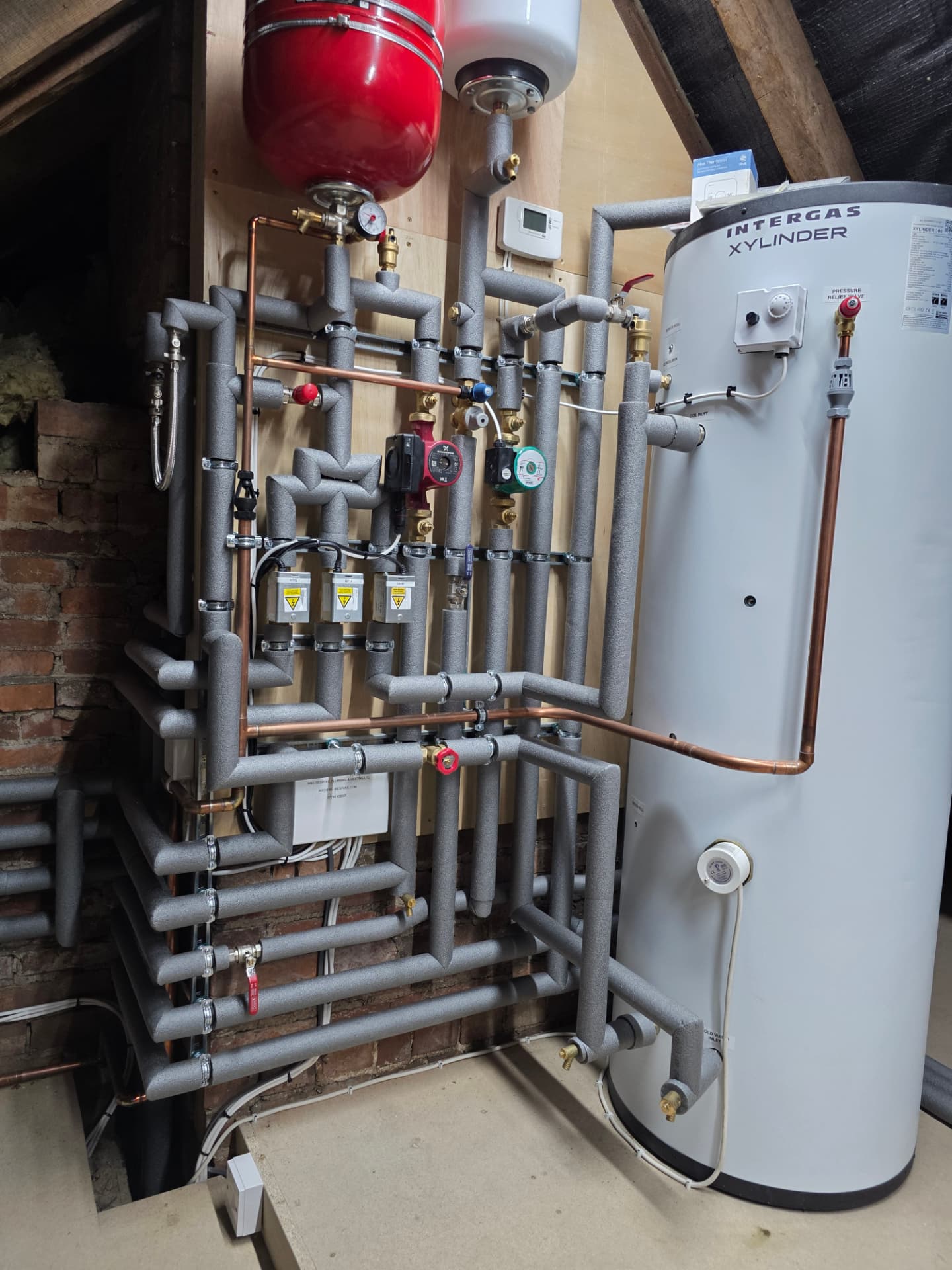 Angled view of an Intergas cylinder and manifold pipework installed by M&S Bespoke in Warwickshire
